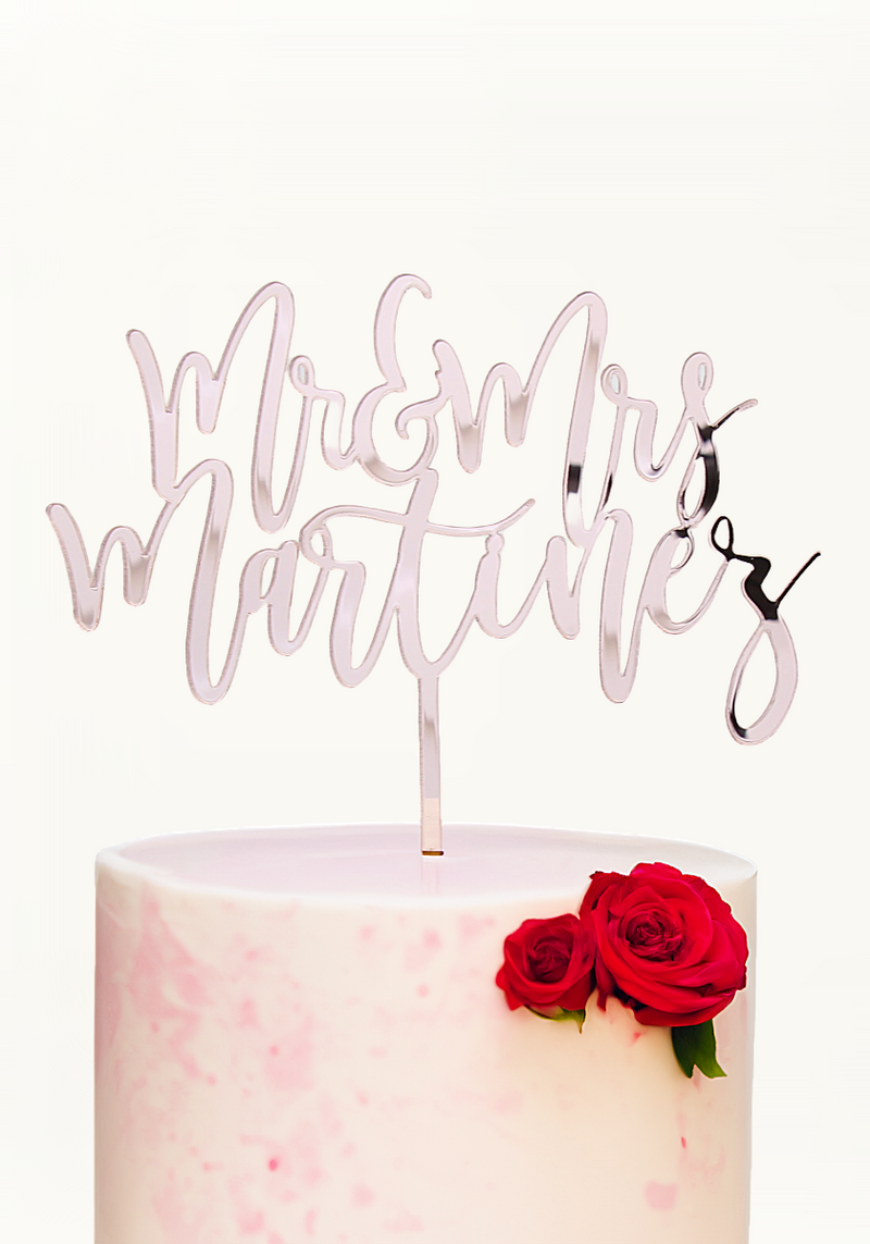 Custom Mr & Mrs wedding cake topper in elegant script on a pink marble cake
