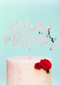 Custom Mr & Mrs wedding cake topper in elegant script on a pink marble cake. Font 1 used