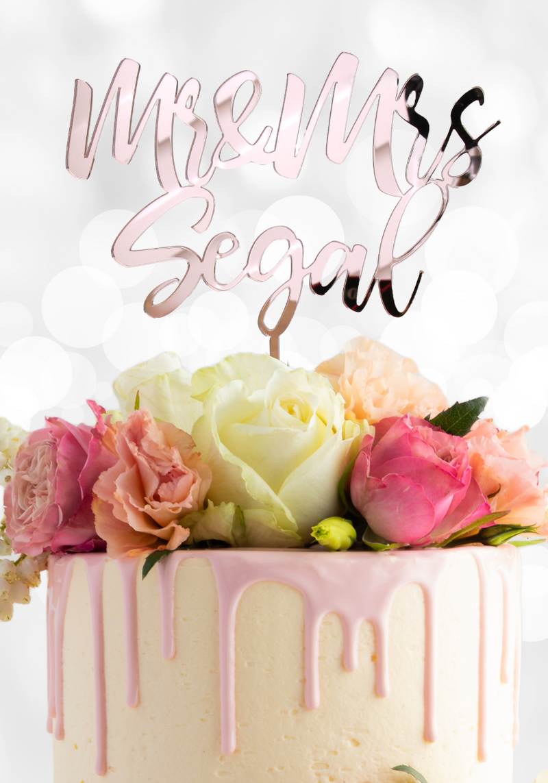 Custom Mr & Mrs wedding cake topper in elegant script on a pink marble cake. Font 2 used